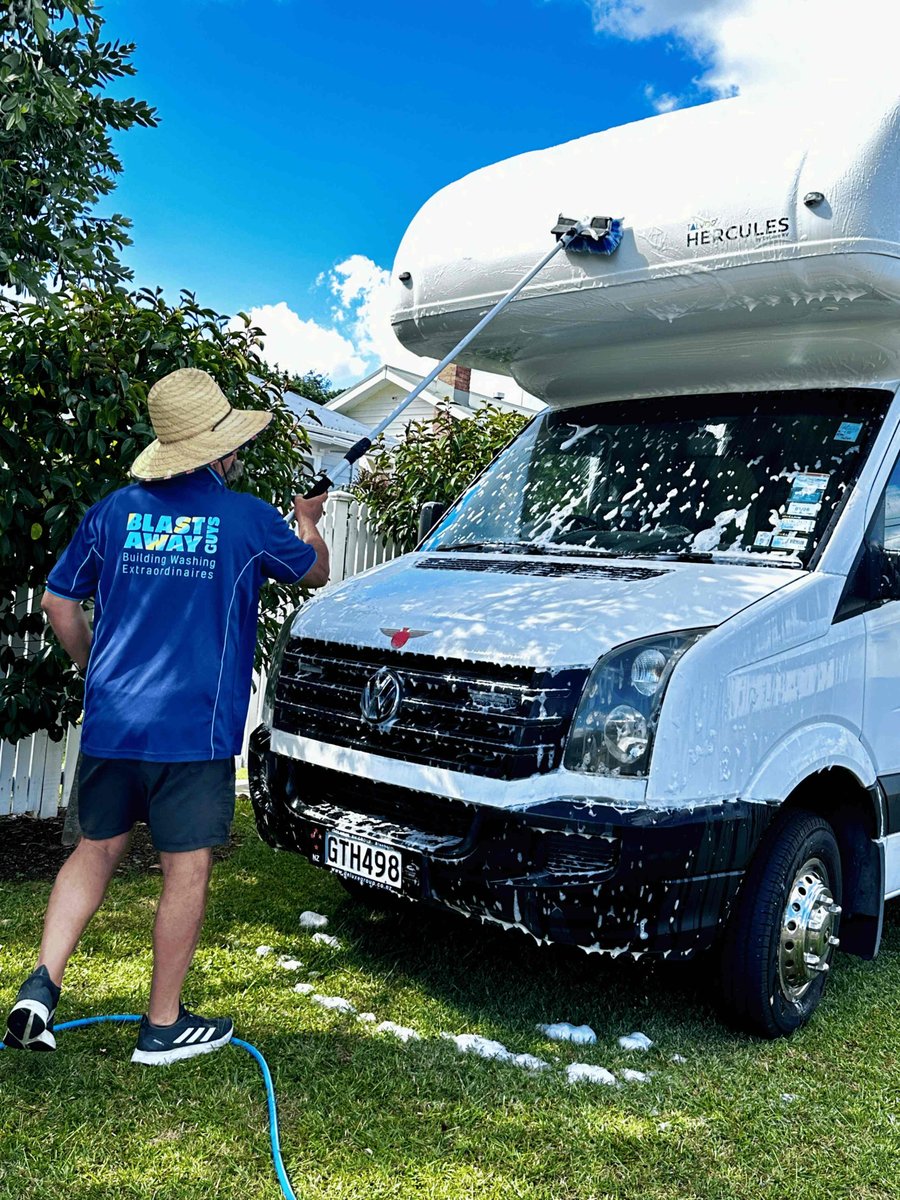 Blast Away Guys technician washing a motorhome in Northland using a soft brush on an extendable pole.
