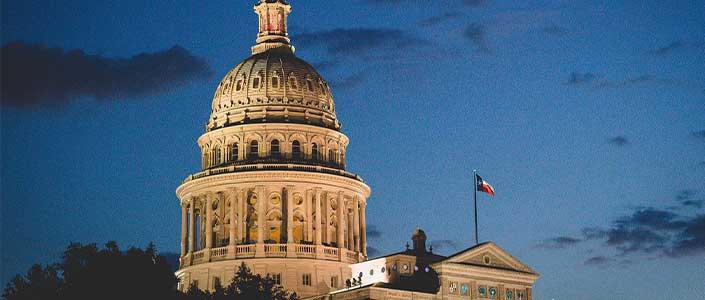 Texas Capital in Austin building lit up at night.