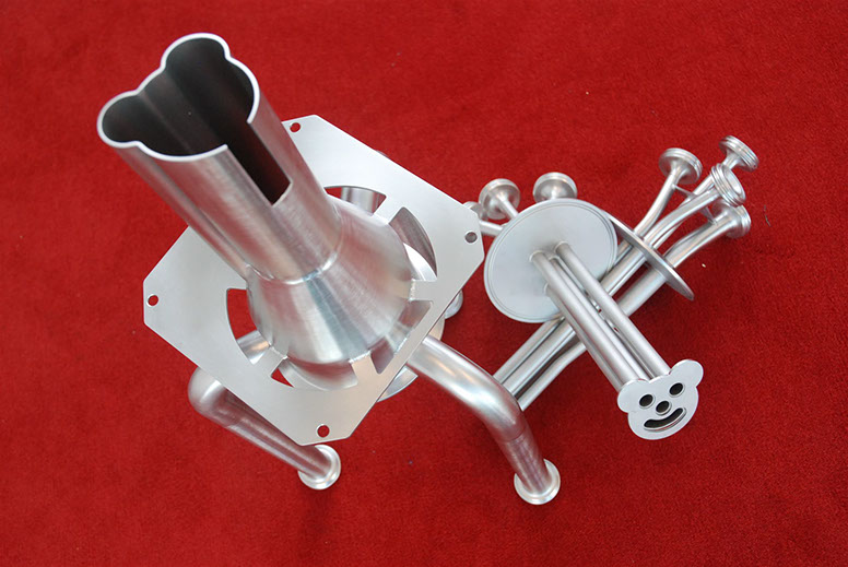 Stainless filling nozzle and pipe assembly on a red background