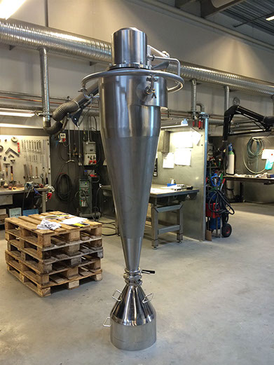Tall conical stainless cyclone in the workshop