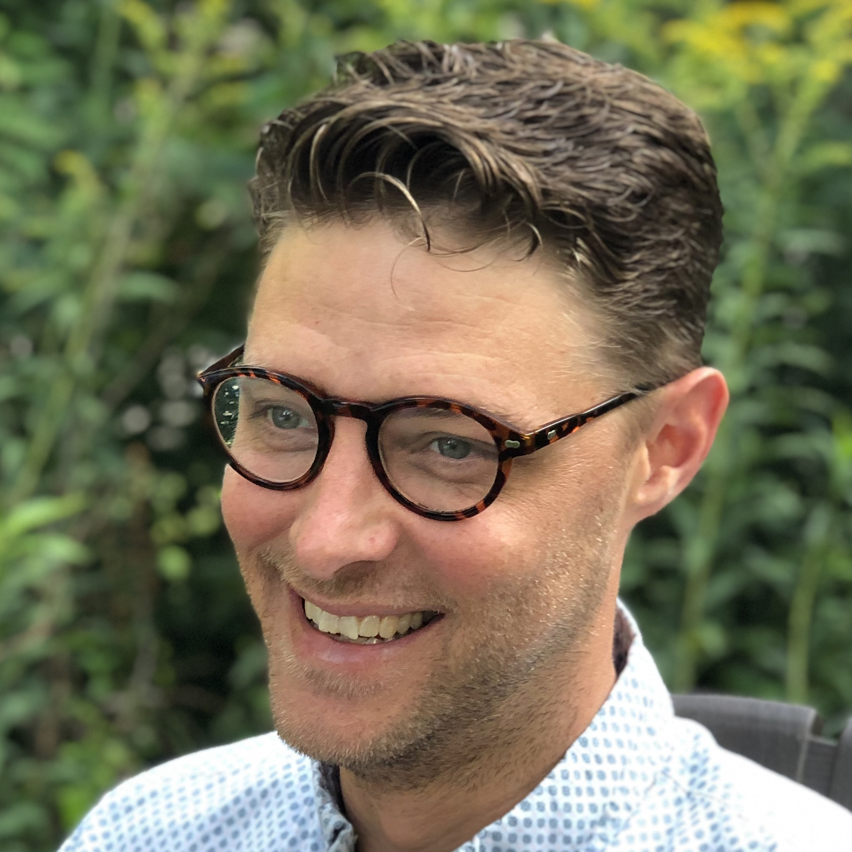 Man with glasses smiling