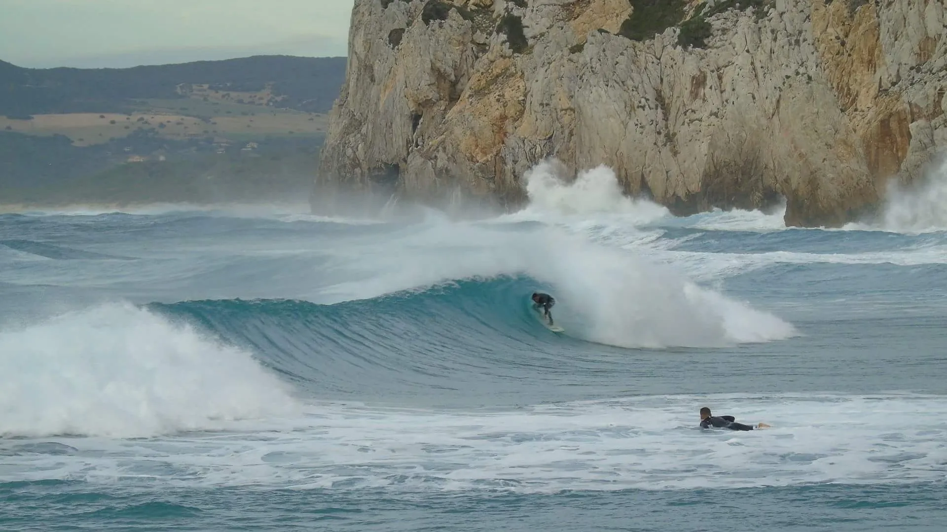 surfing getting barreled in sardinia