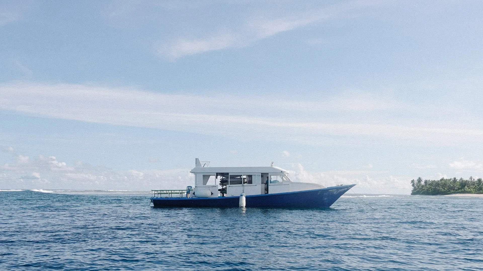maldivian dhoni support boat with surfboards inside