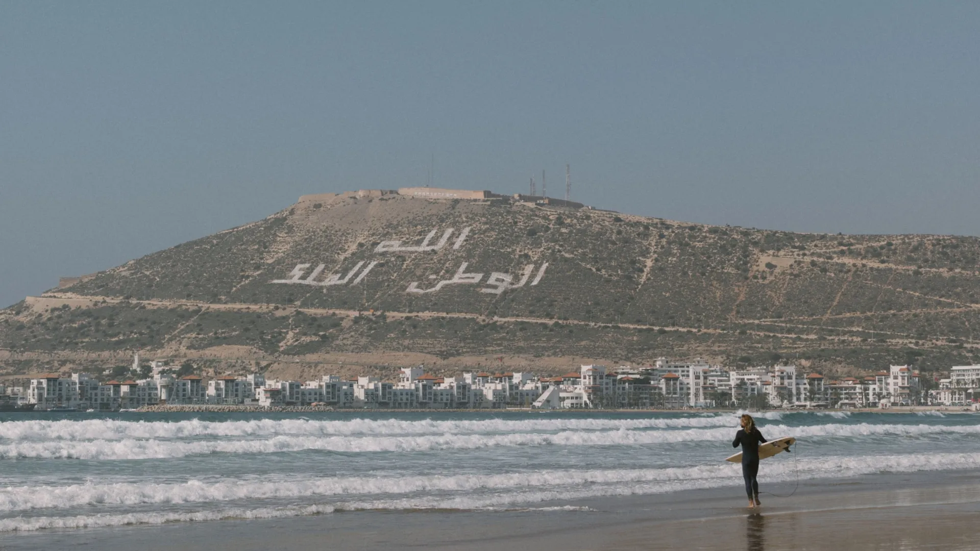 Surfer standing on the beach in agadir