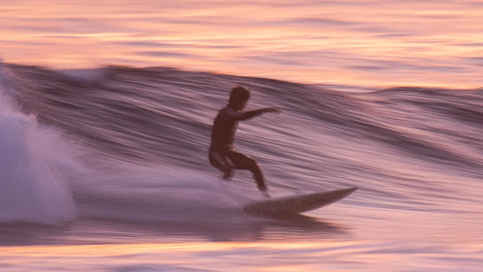 backside bottom turn at sunset