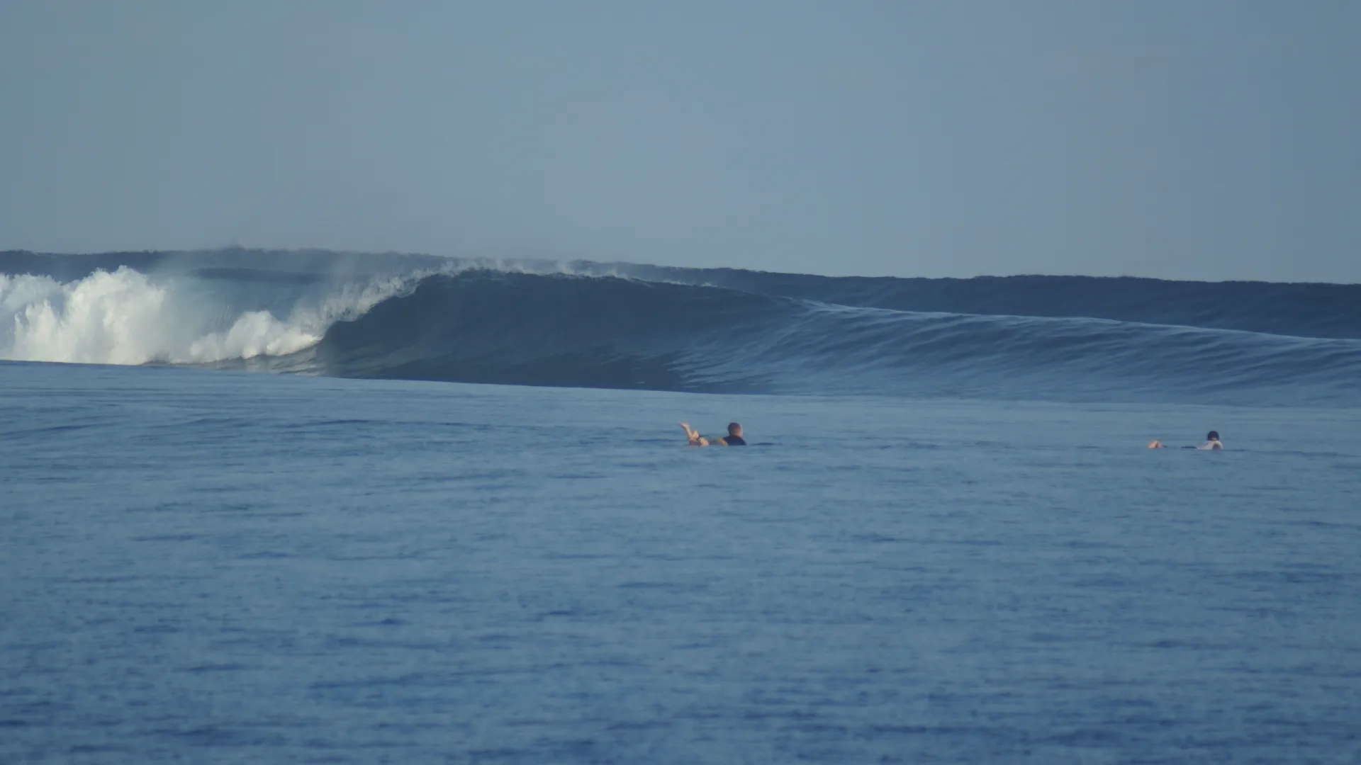 two surfers in an empty pumping lineup