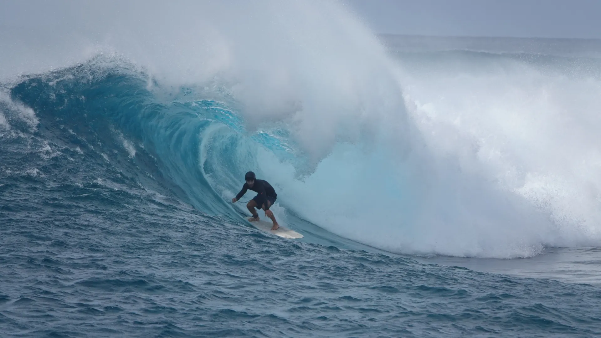 big wave in the maldives pitching over a surfer