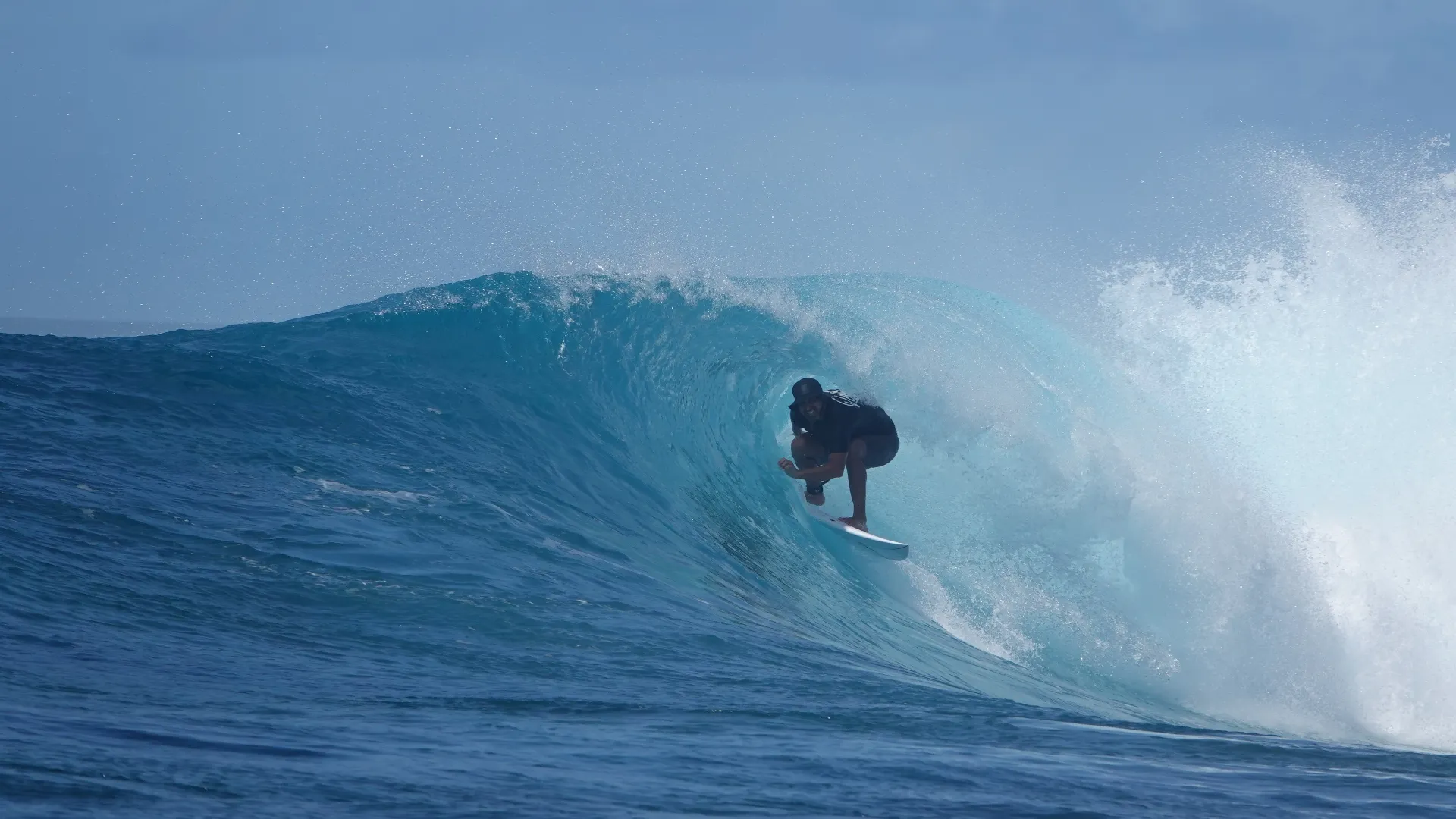surfer riding the barrel in the southern atolls in the maldives