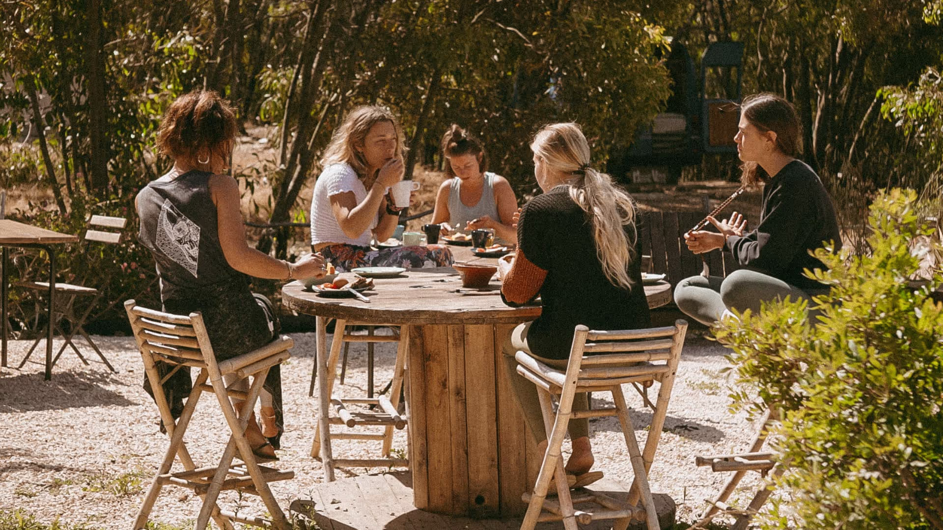 Group of female friends having breakfast at the glamping