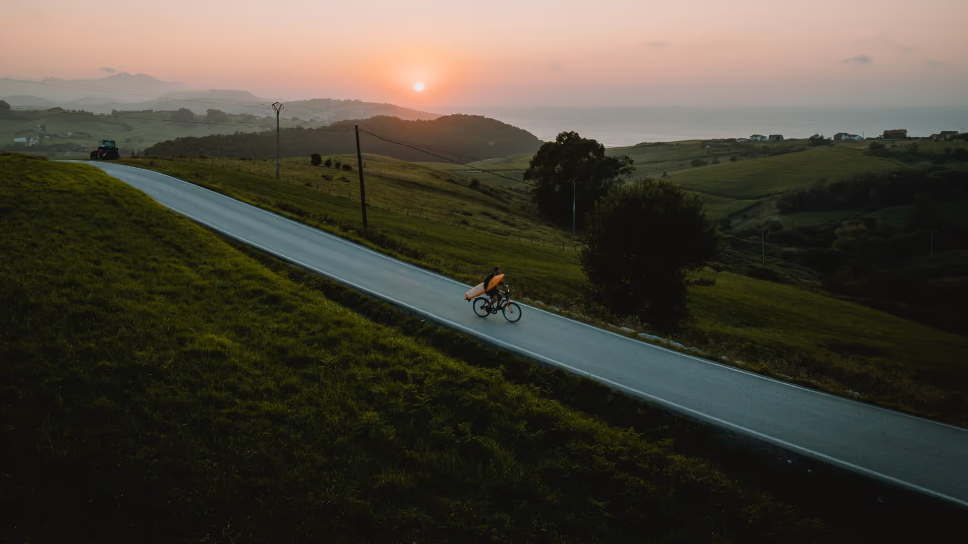riding a bike with surfboard in spain