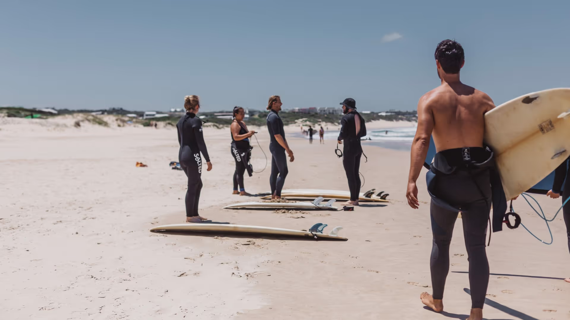 surfers on the beach in south africa
