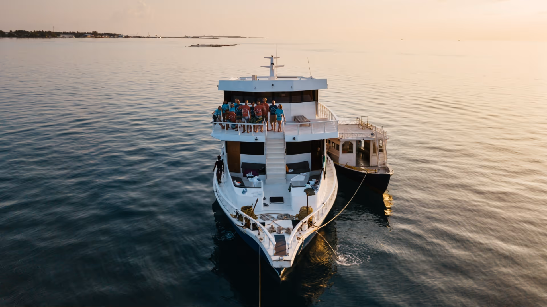 View of the boat with crew and guests, from the side