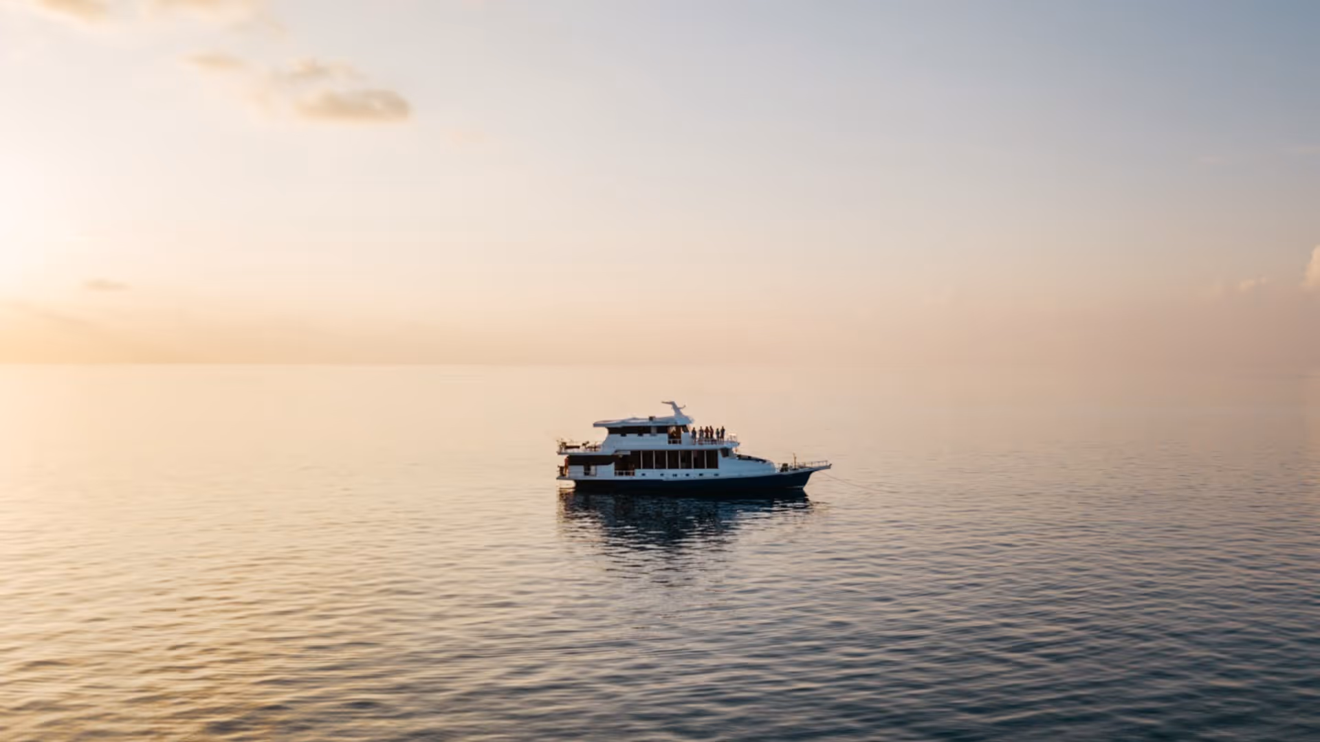 Boat floating at sunset