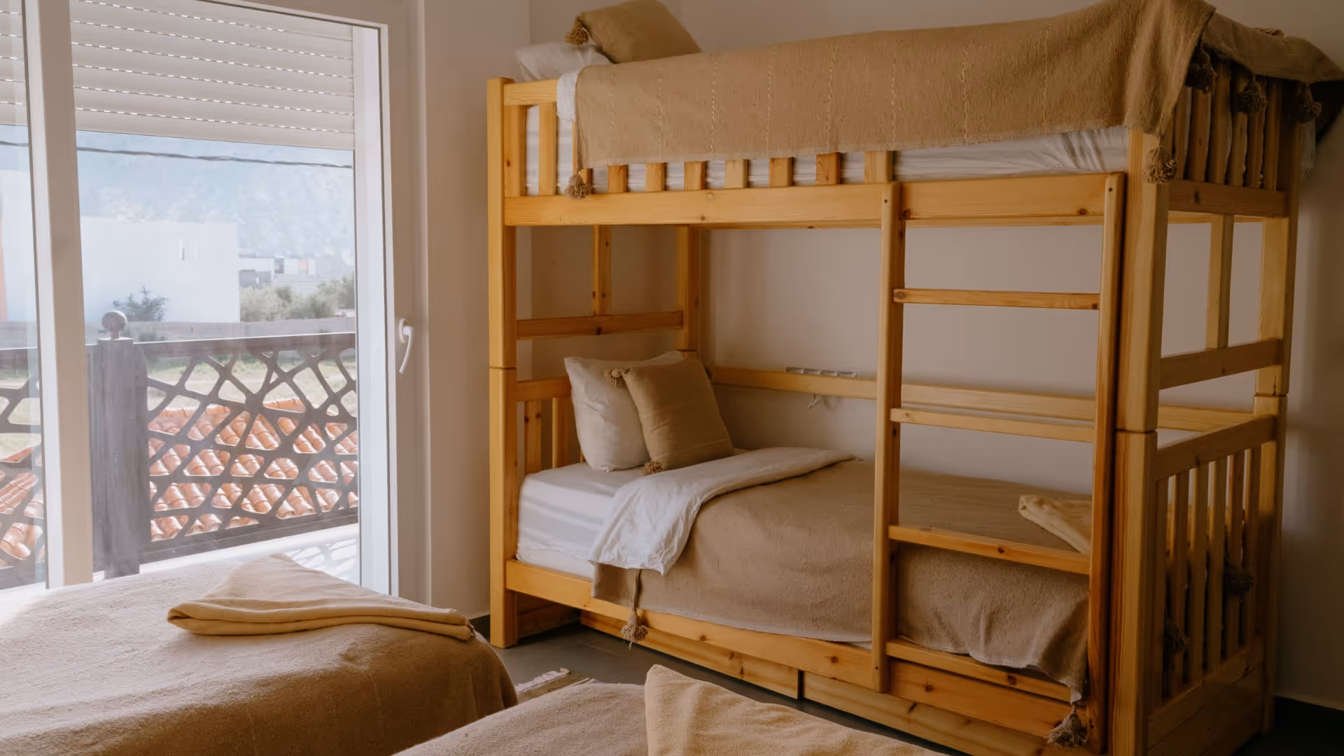 Dorm room with bunk bed and two single beds