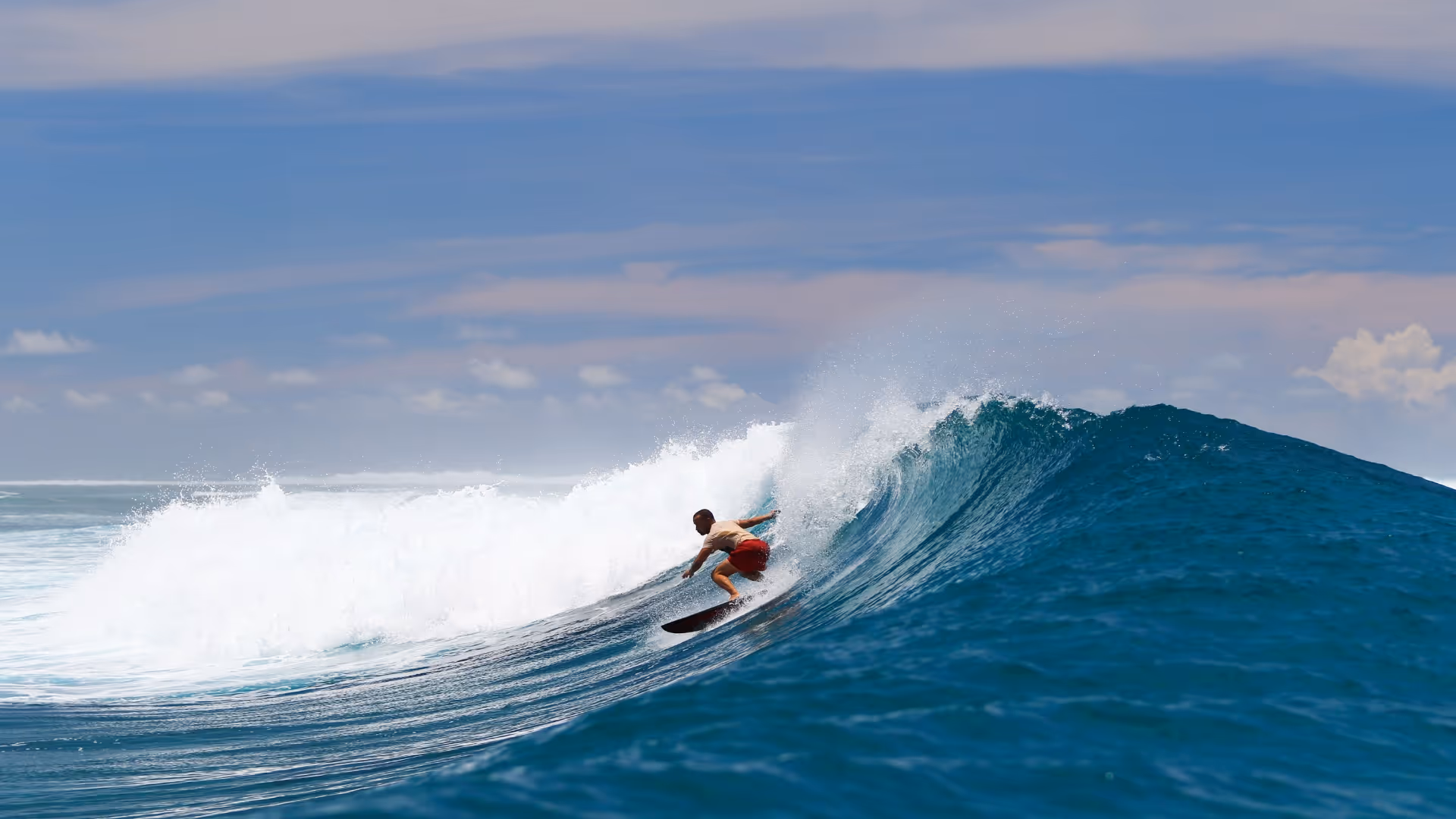 surfer going left on a very good blue wave