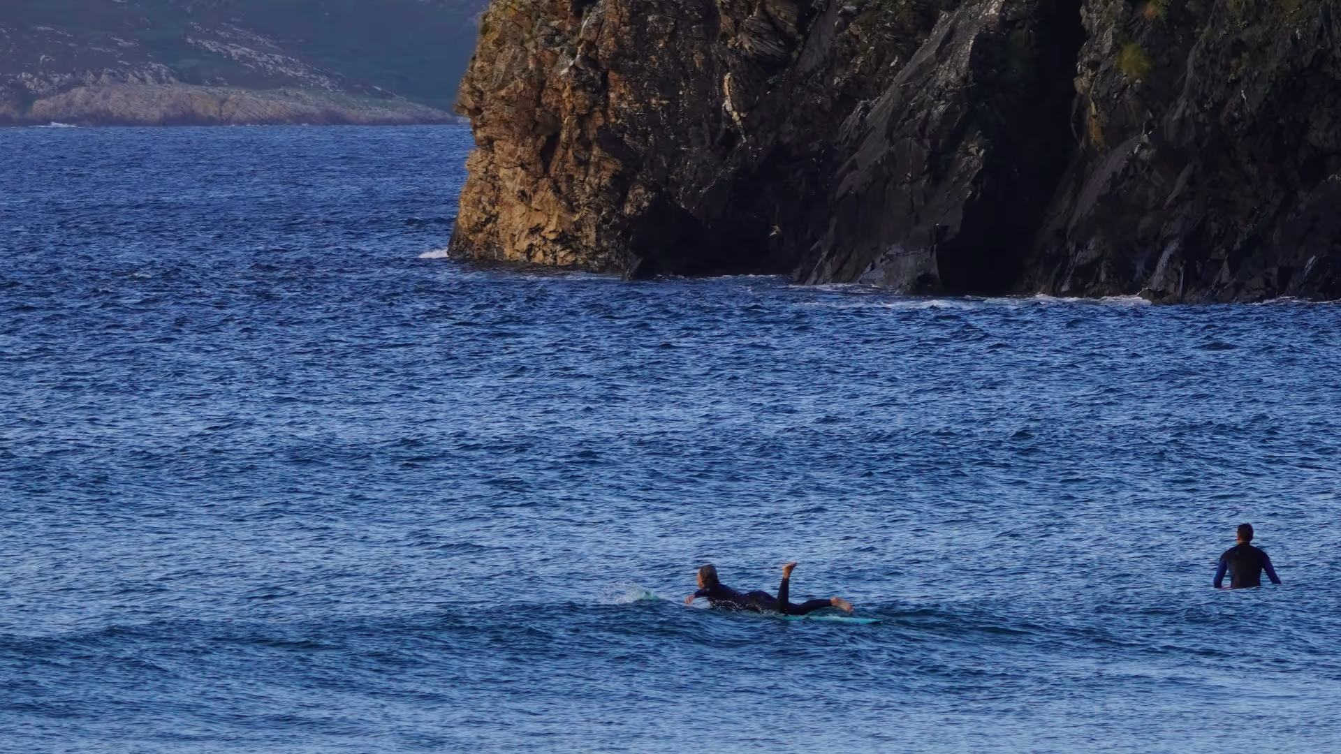 two surfers in the water in ireland