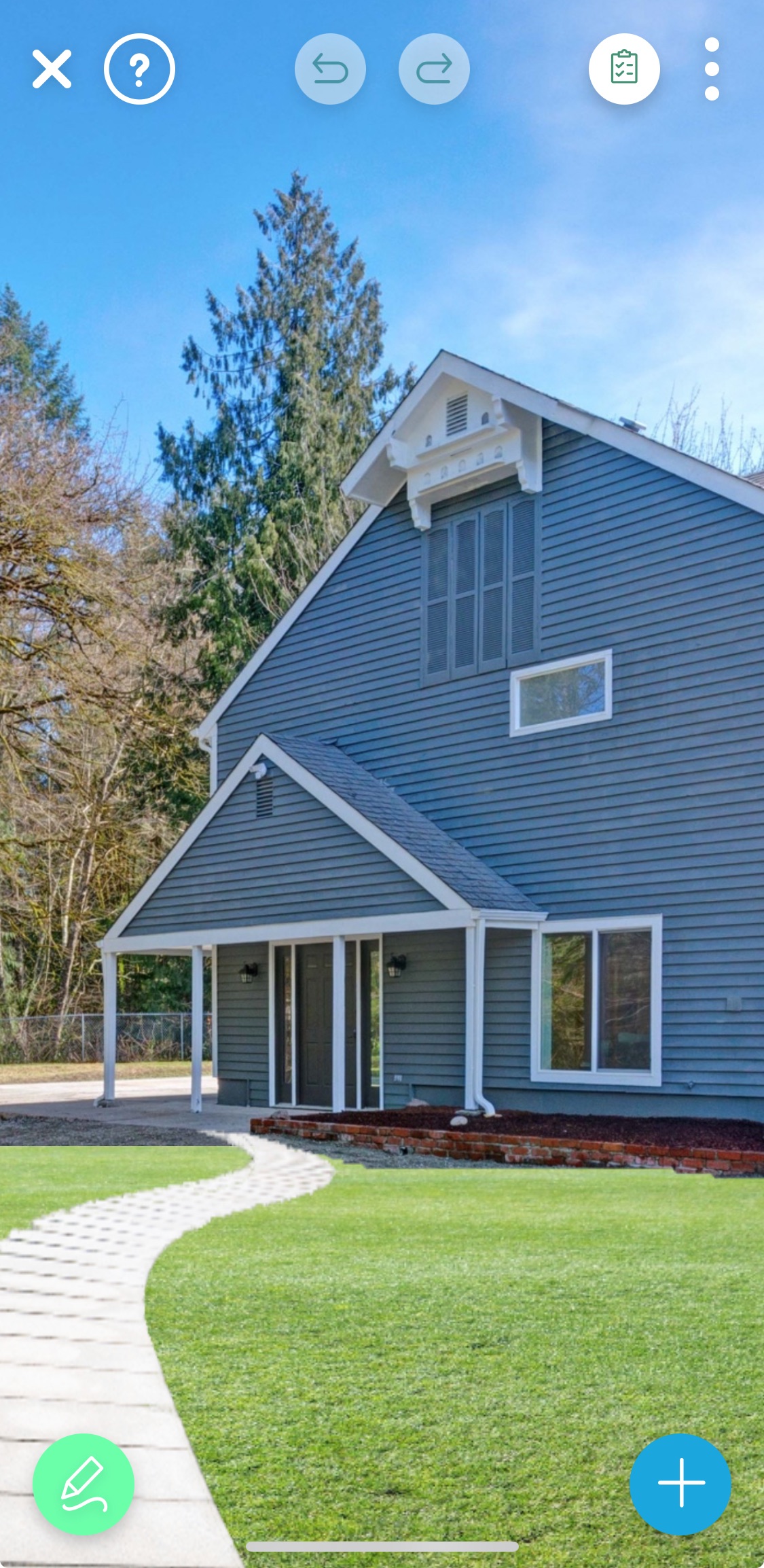 Modern gray two-story home with a white porch and curved stone walkway, ready for landscape design using the iScape app.