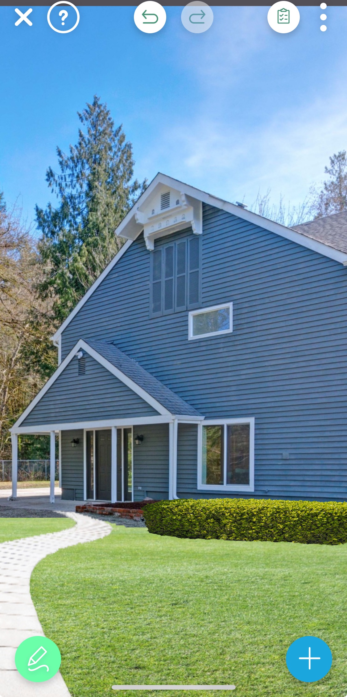Front view of a modern gray home with white trim, a curved stone walkway, and neatly trimmed green hedge designed in the iScape app.