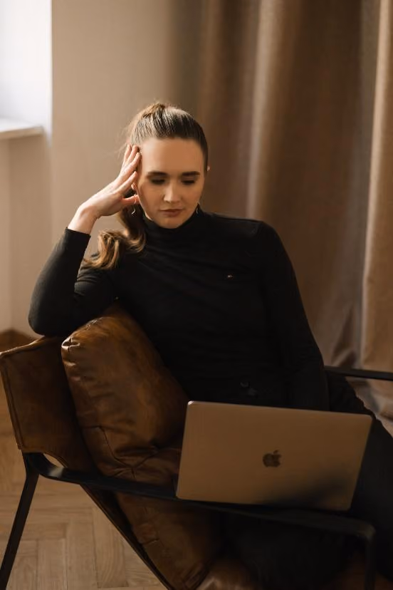 A person sitting in a chair with a computerAI-generated content may be incorrect.