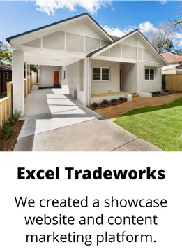 Modern single-story house with white exterior, covered carport, and a green lawn under a blue sky.
