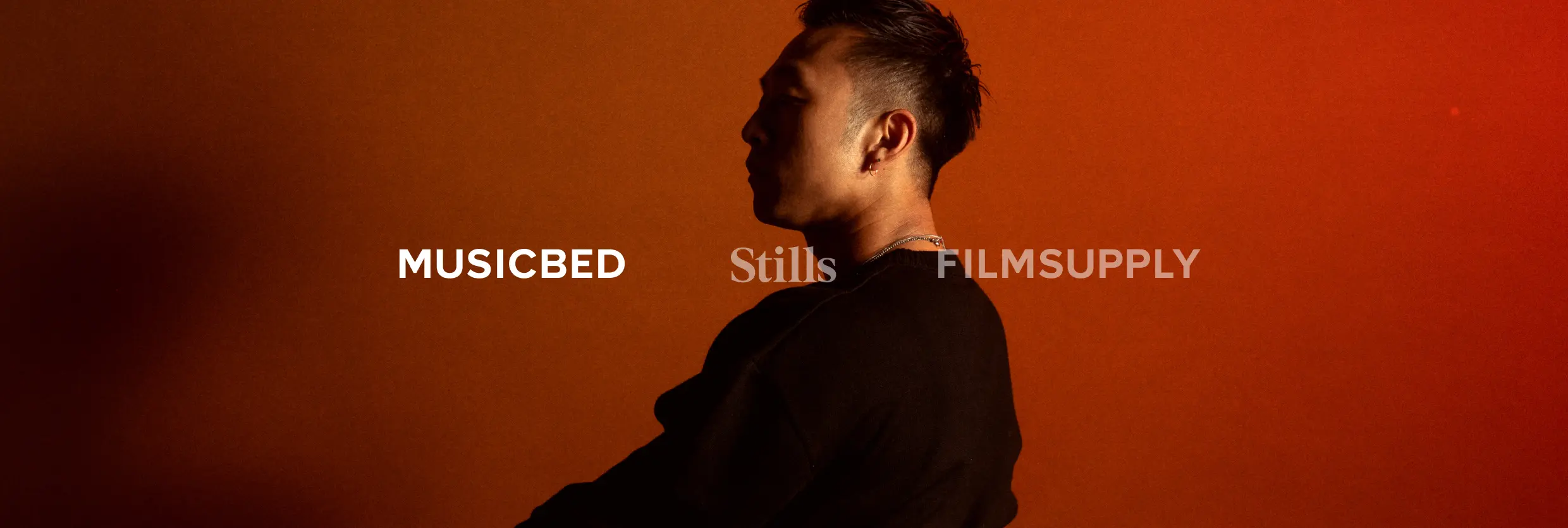 A person looking off screen with the text Musicbed overlaid
