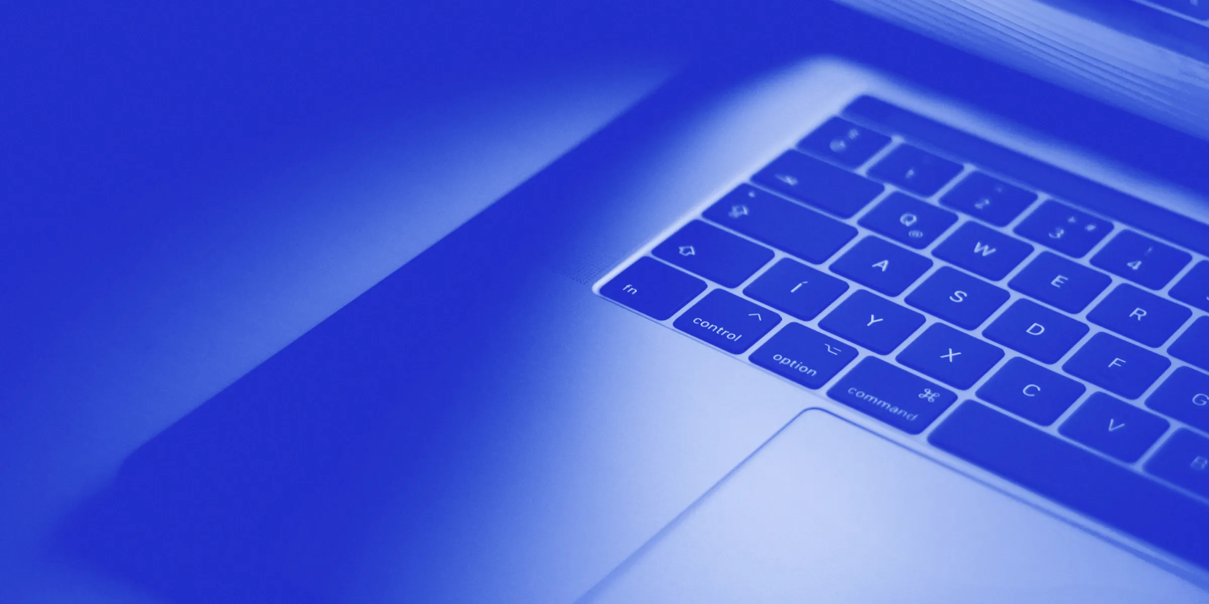 A close up image of a laptop computer, styled with a blue gradient overlay