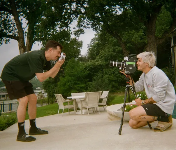 Two men are taking picture of each other using camera