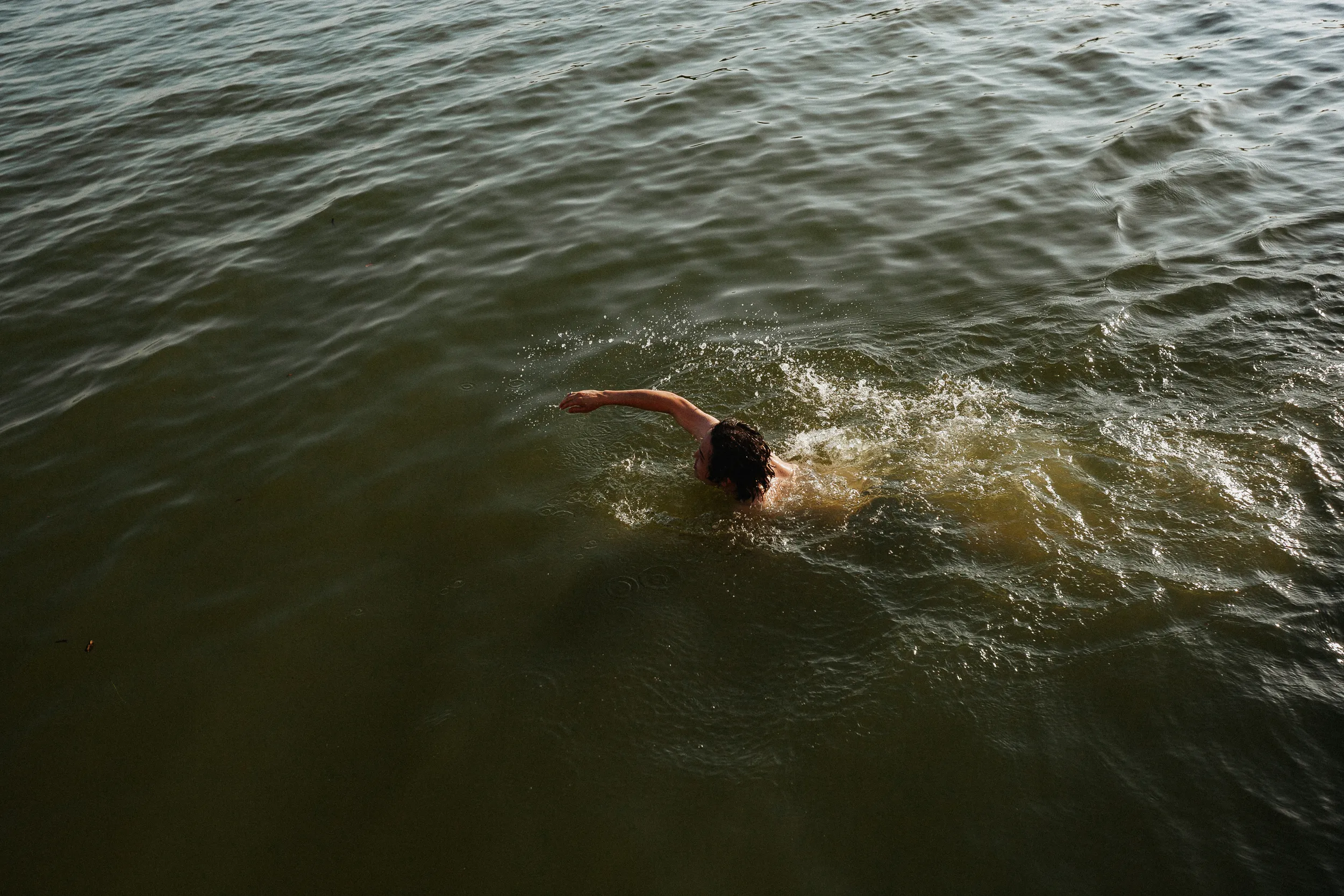 Man Swimming In Lake
