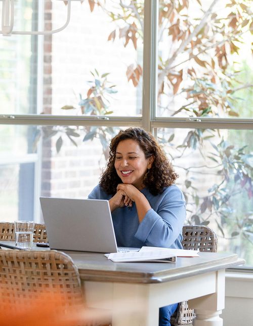 A person smiling during an online therapy session