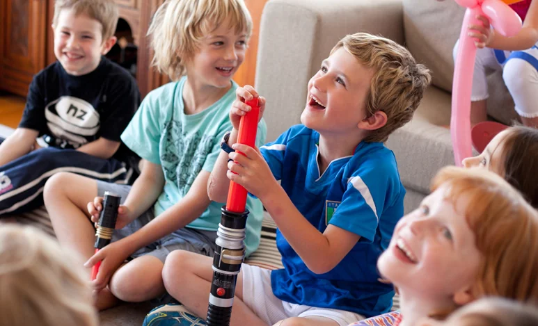 Children watching a magic show in Auckland