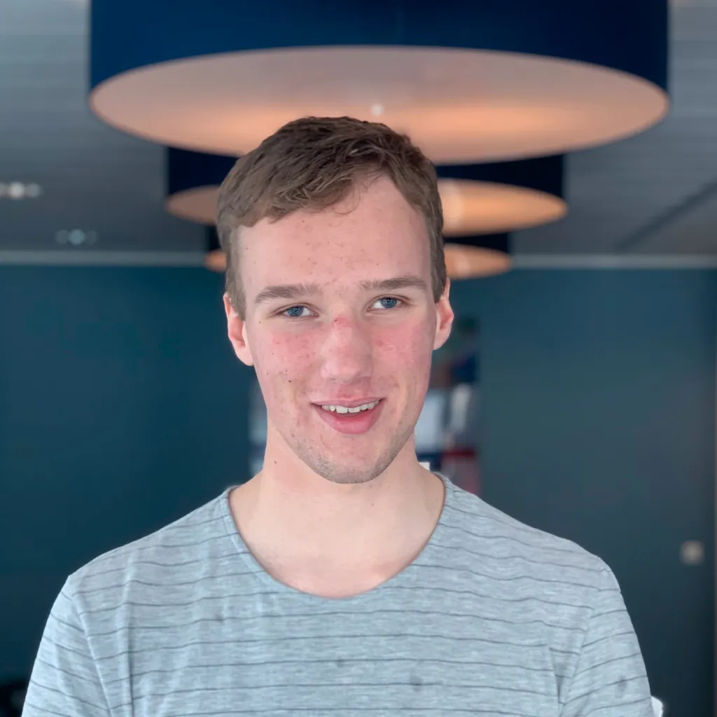 Photo of Jesse Wienholts curiously smiling for the camera