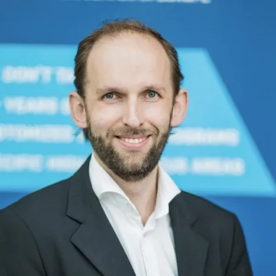 Picture of David in a suit smiling for the camera