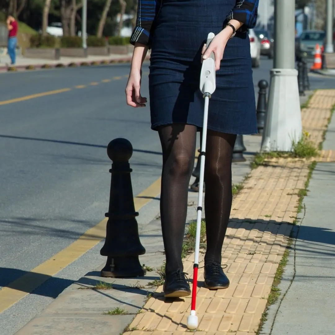 A picture of a woman using a smart cane
