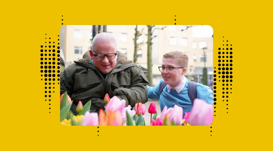 a photo of brian dalton and his assistant rachel. he is wearing the envision lasses and checking out tulips in amsterdam