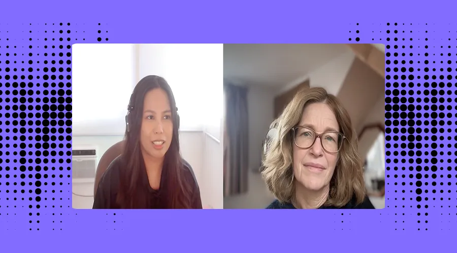  A split-screen video call between two women against a purple background with a dotted pattern. The woman on the left has long dark hair, wears headphones, and is in a bright room with a window. The woman on the right has shoulder-length wavy blonde hair, wears glasses, and is in a room with slanted ceilings and curtains. 