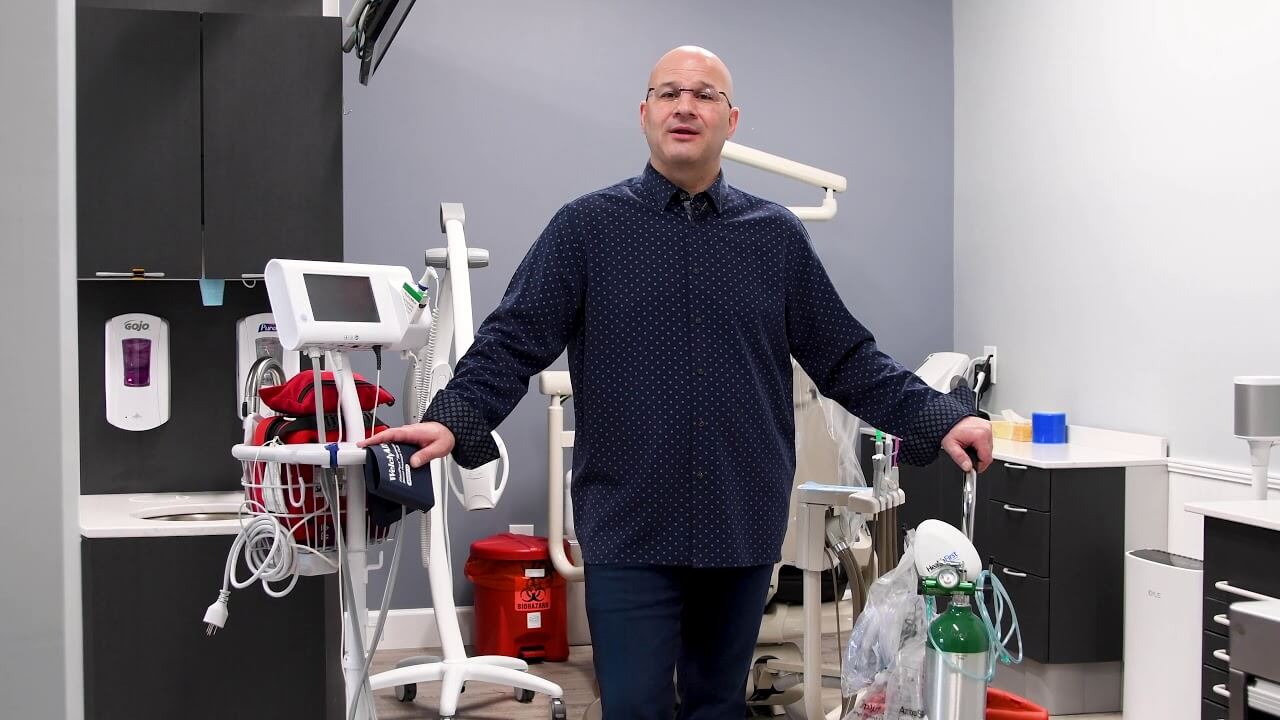 Dr. Abbiati stands next to his dental tools and equipment. 