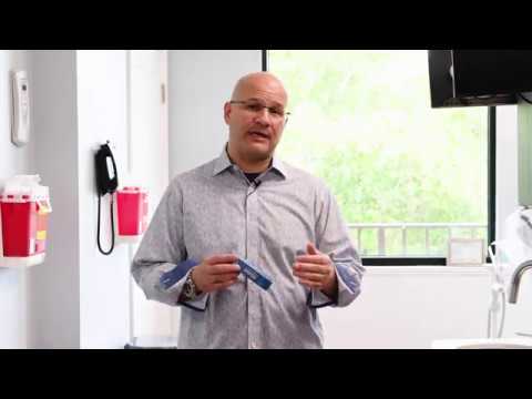 Dr. Abbiati holds an Allday Dry Mouth Spray box