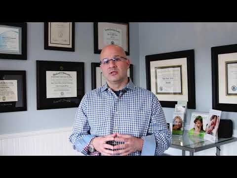 Dr. Abbiati stands in his patient waiting room describing the difference between veneers and crowns 