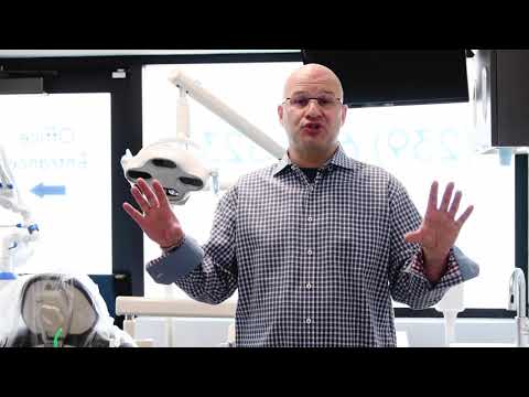 Dr. Abbiati speaks to camera with hands raised