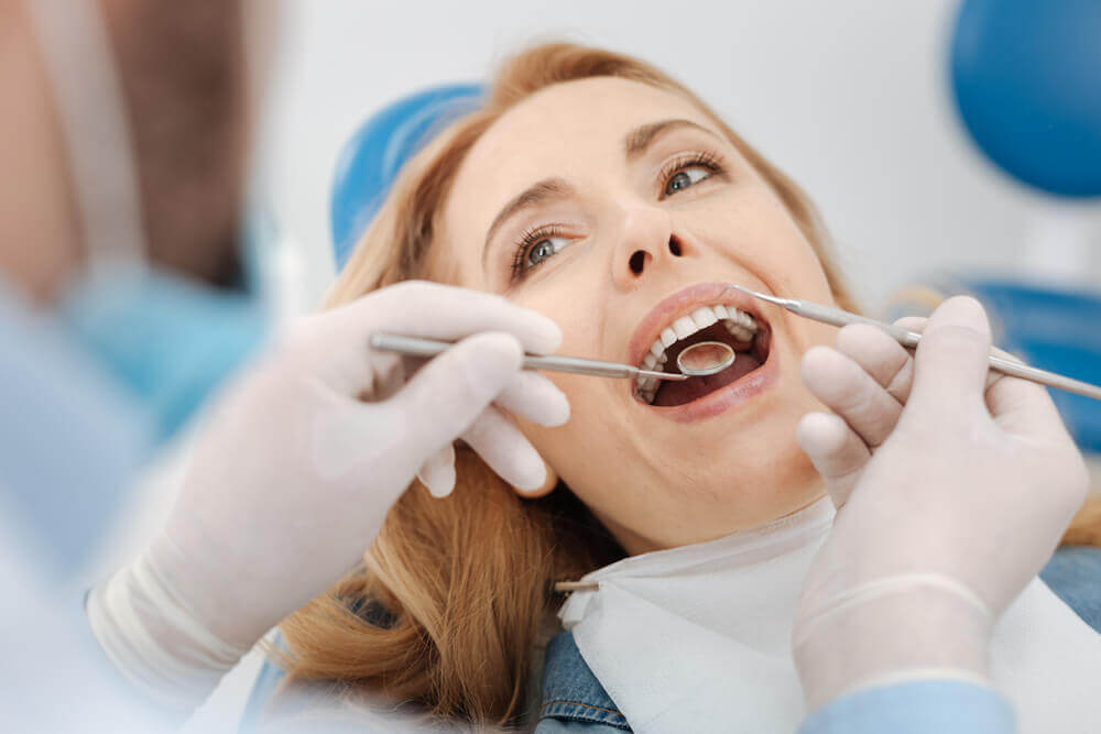 dentist in Marco Island checking a patient