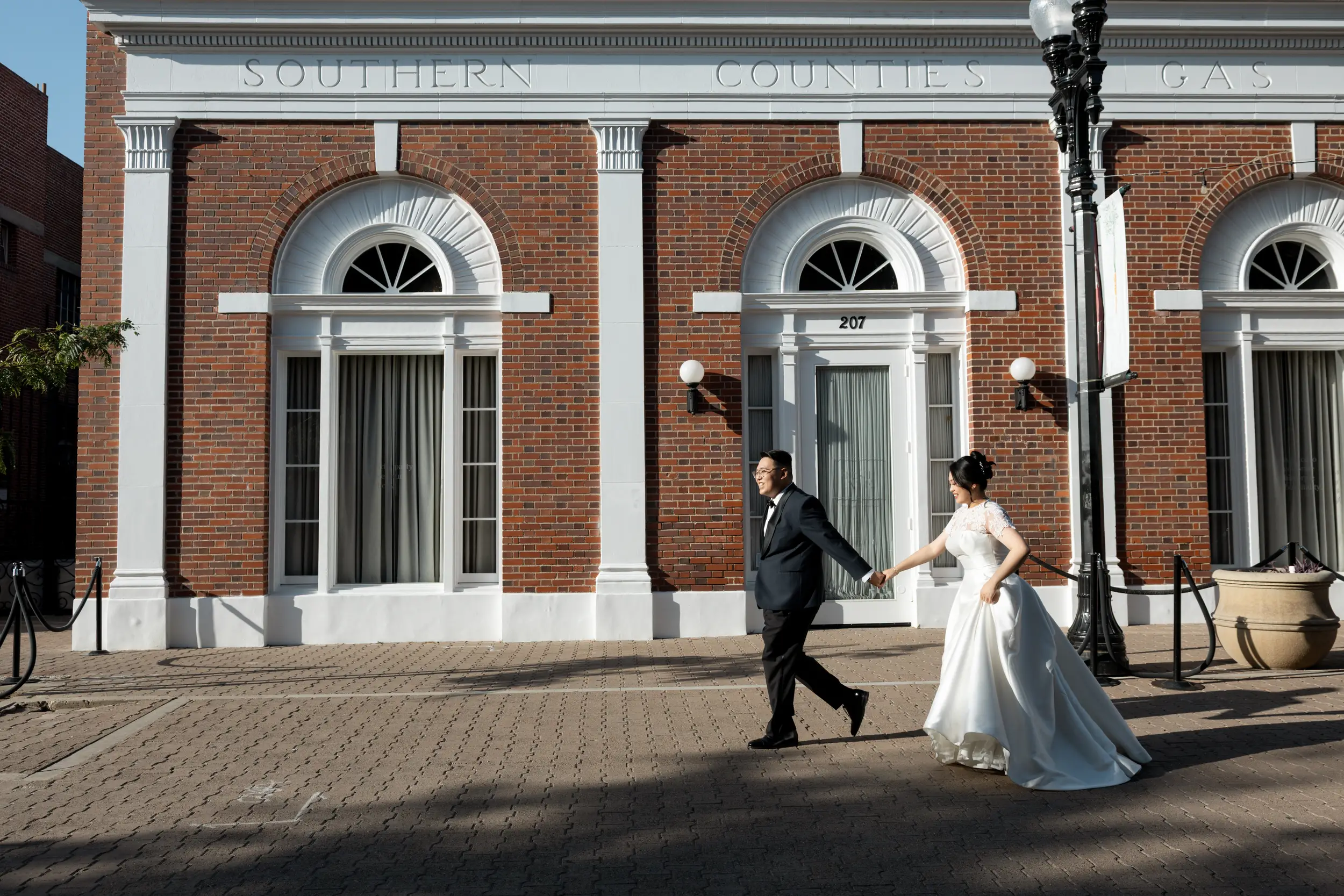 Bride and groom pose for photos outside of the Estate on Second in Santa Ana.
