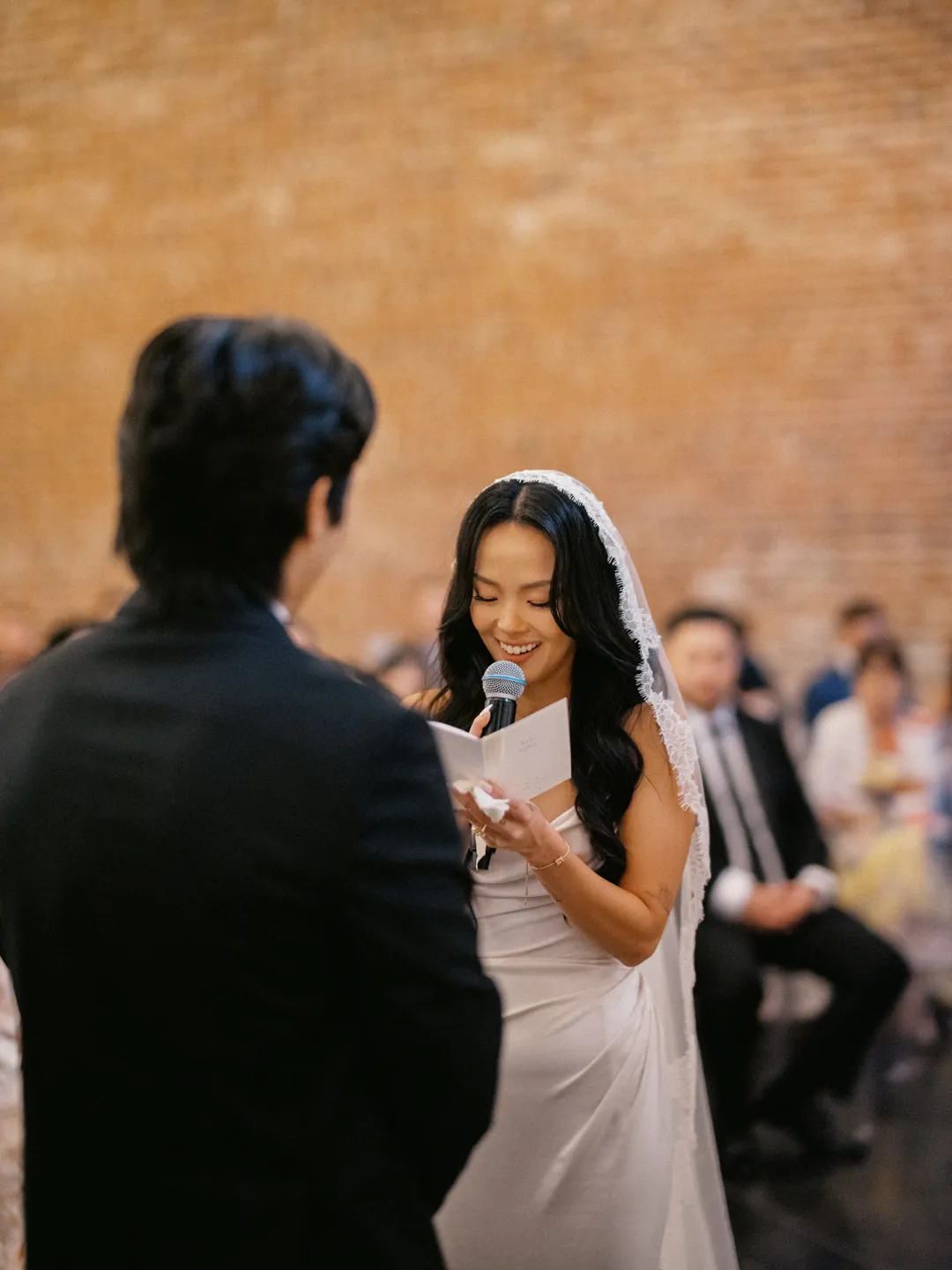 Bride reading vows while facing the groom