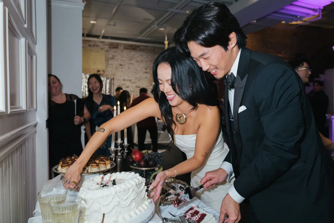 Couple cutting a cake together