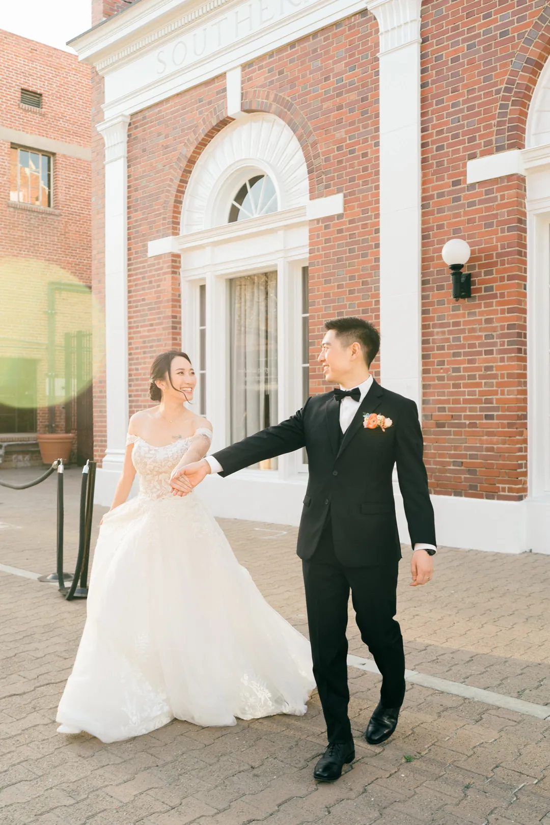 Couple walking outside a brick building