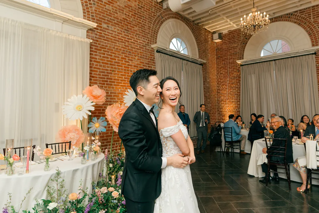 Newlyweds entering their wedding reception
