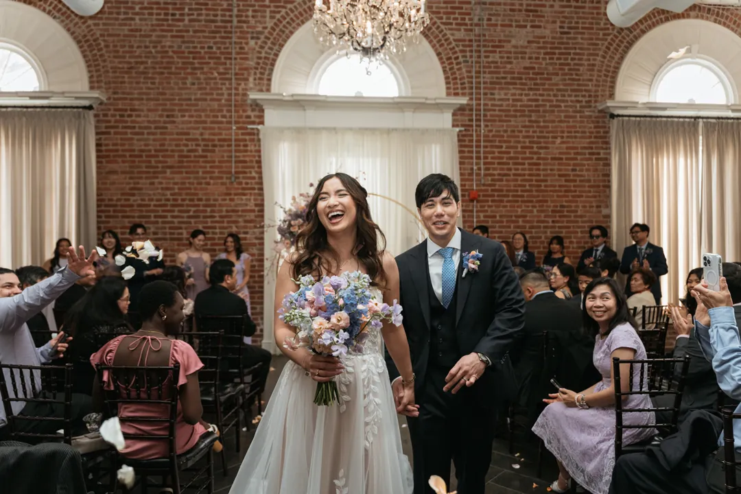 Newlyweds walking down the aisle together