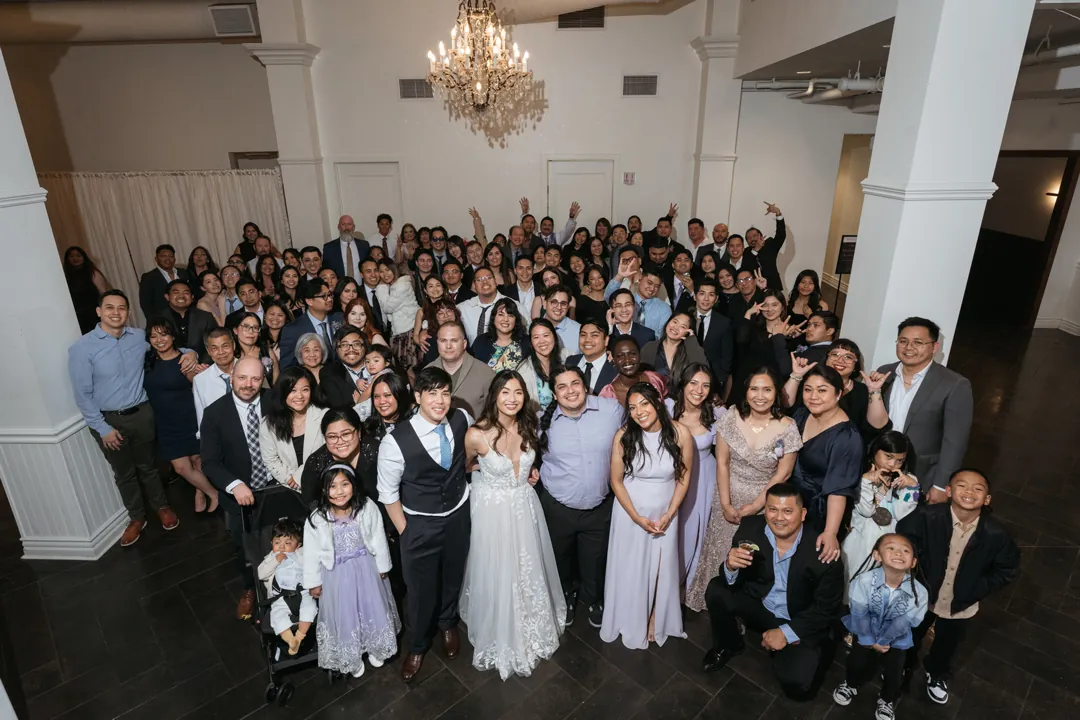 Large group of wedding guests posing together