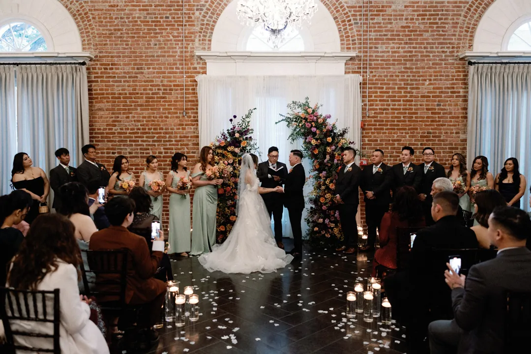 Guests watching a couple exchange vows