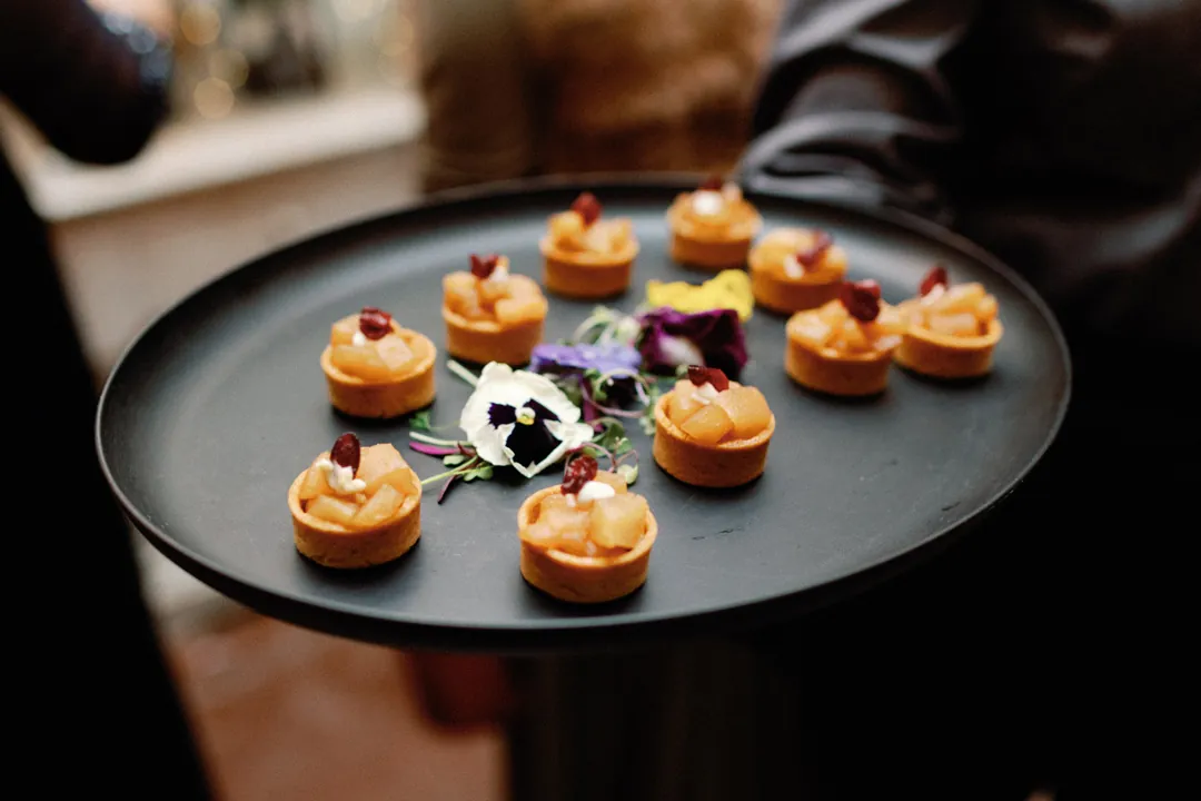 Small appetizers on a black serving platter
