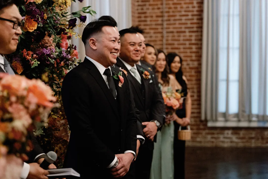 Groom smiling during his wedding ceremony